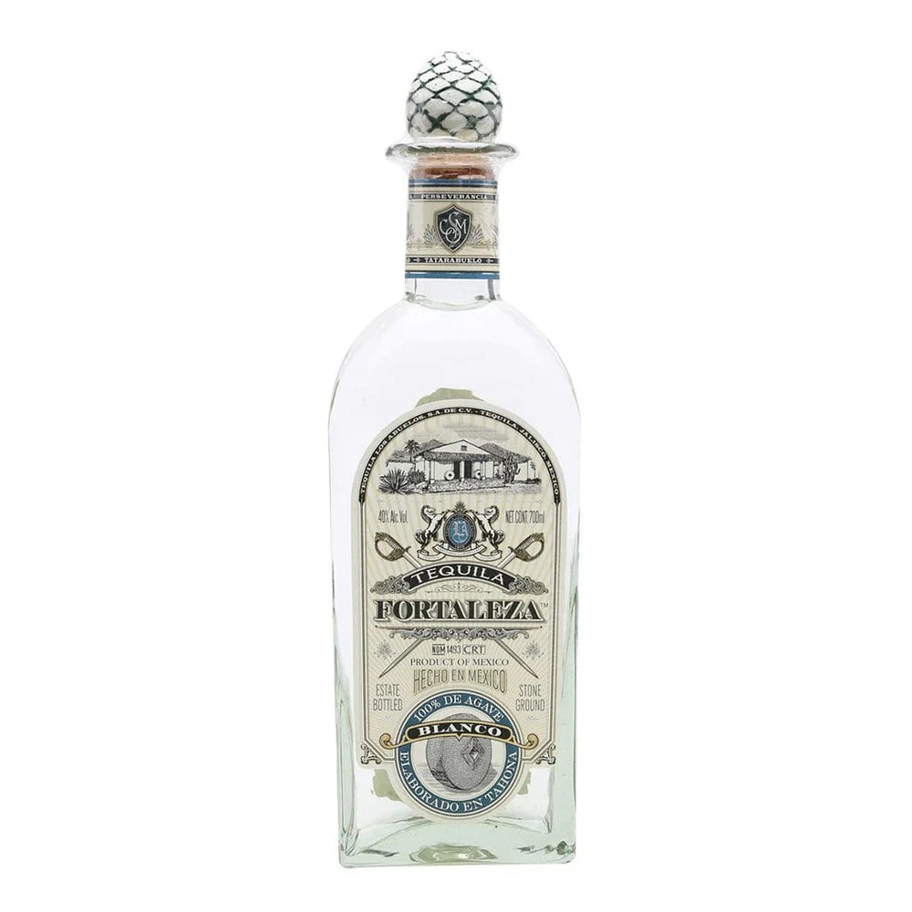Tequila bottle with decorative cap on a white background