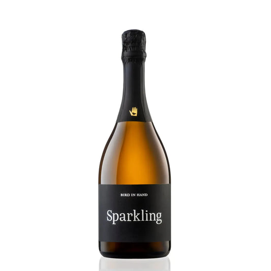 Bottle of sparkling wine with a black label on a white background