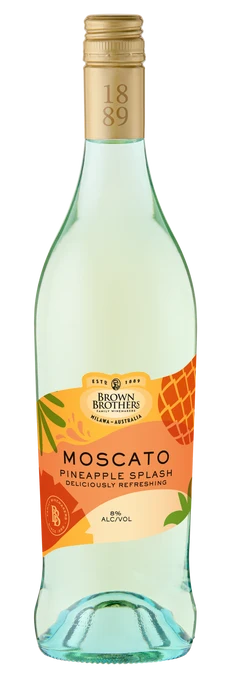 A bottle of Brown Brothers Moscato Pineapple Splash non-alcoholic wine, featuring a pale greenish-white liquid, a gold screw cap, and a label with orange and yellow pineapple graphics.