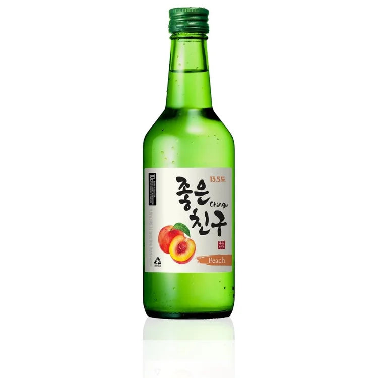 A green glass bottle of Korean soju liquor with a green cap and a white label featuring peach illustrations and Korean text, set against a plain white background with a soft reflection below.
