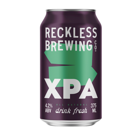 A can of Reckless Brewing XPA beer with a purple label, indicating 4.2% ABV and 100% natural ingredients.