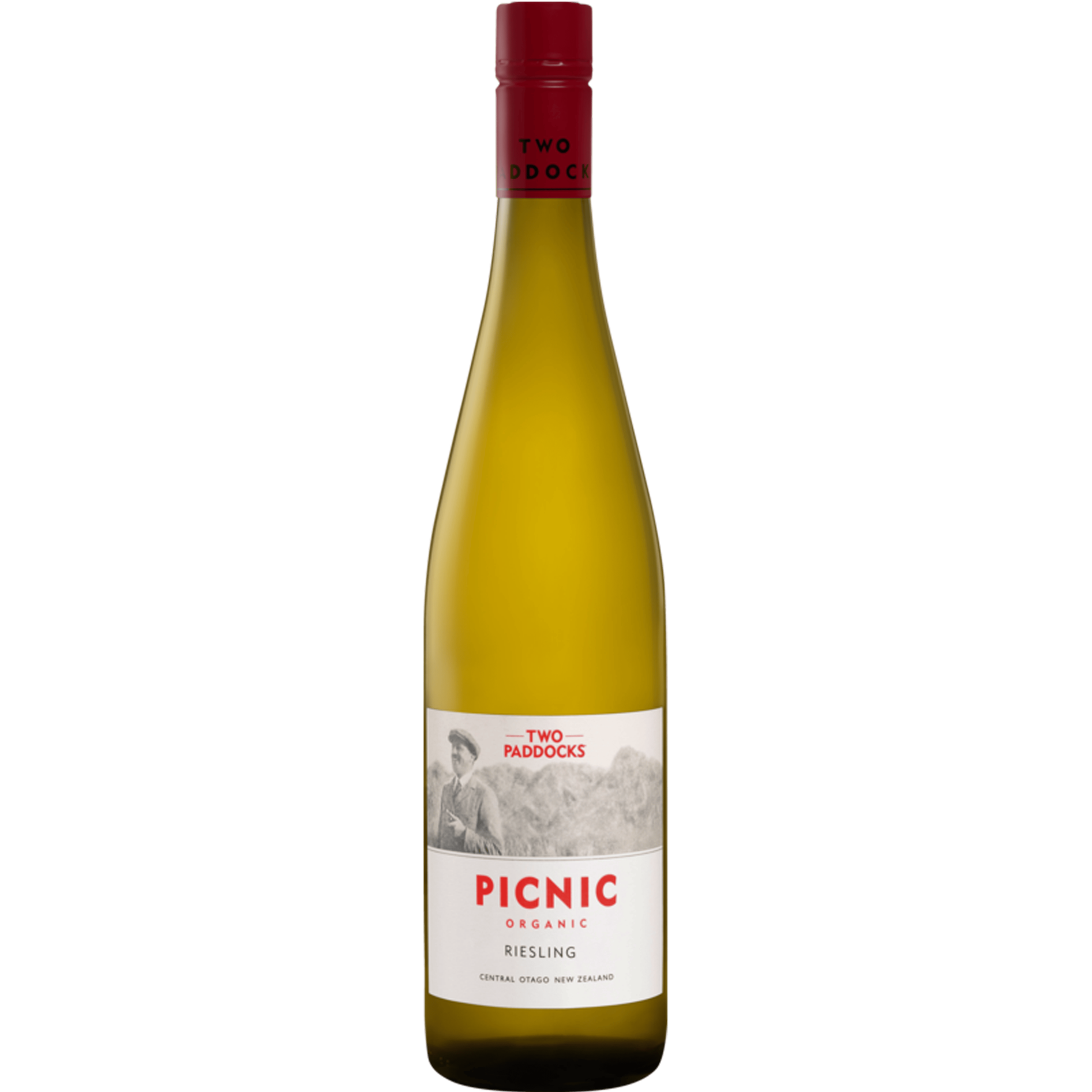 A bottle of Two Paddocks Picnic Organic Riesling white wine, featuring a pale golden-yellow liquid, a white label with red and black text, and a dark red screw cap, set against a solid green background.