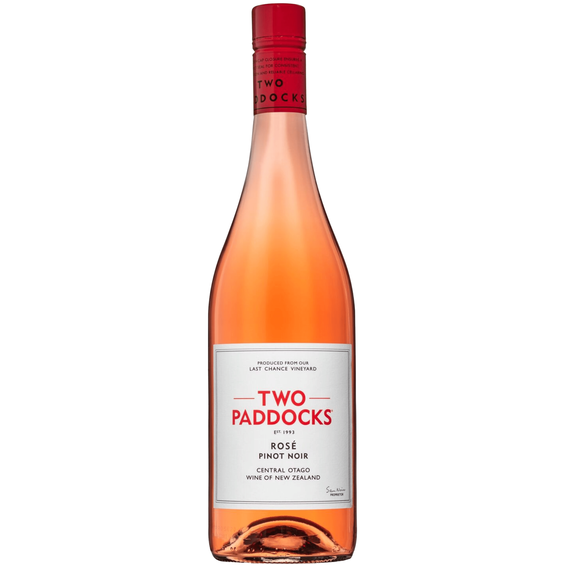 A bottle of Two Paddocks Rose Pinot Noir wine against a solid green background. The bottle contains a pinkish-amber liquid, has a white label with red and black text, and a red foil neck seal.
